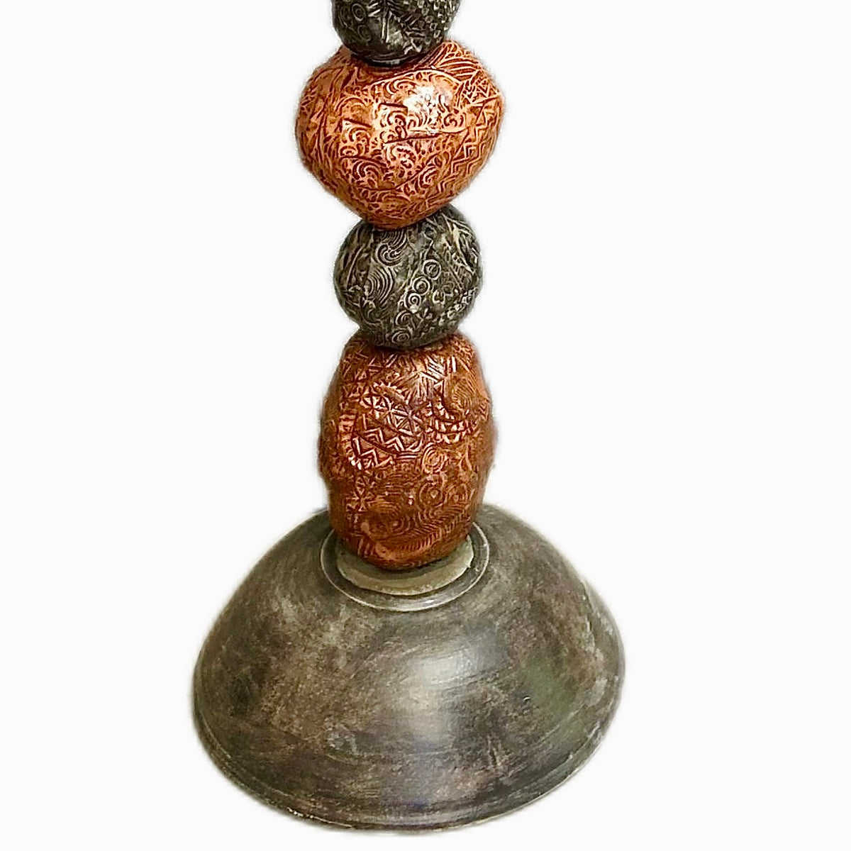 Stone Perch 2 by Zimmerman – close-up of hand-incised sphere pattern in copper ceramic that can be found rather than announced in courtyard corner