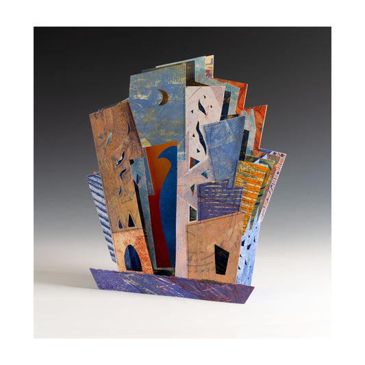 Amparo – sculptural artist book by Ruiz with pages fanning into architectural layers of warm earth, cobalt, and deep teal, pages folding like walls around a courtyard as shelter and protection