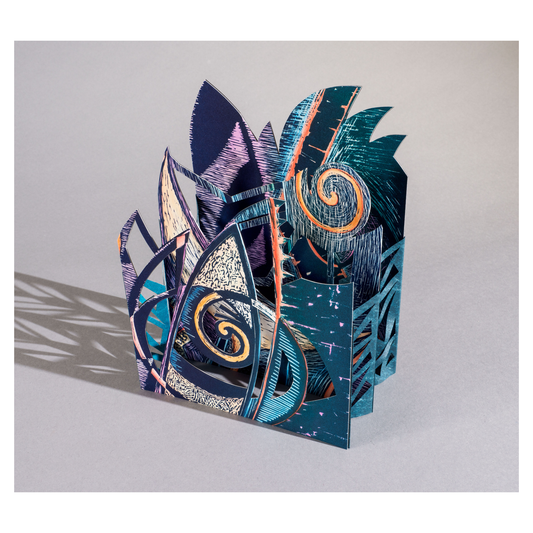 Luna Mar – small sculptural carousel book by Ruiz in deep teal and navy blue with cut and printed wave, crescent moon, and spiral forms evoking the relationship between sky and sea
