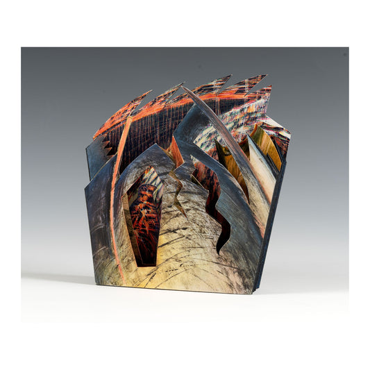 Awaken – small sculptural accordion book by Ruiz in deep rust, teal, and warm earth tones with pages cut into irregular forms suggesting landscape, architecture, or layered riverbank sediment at a threshold