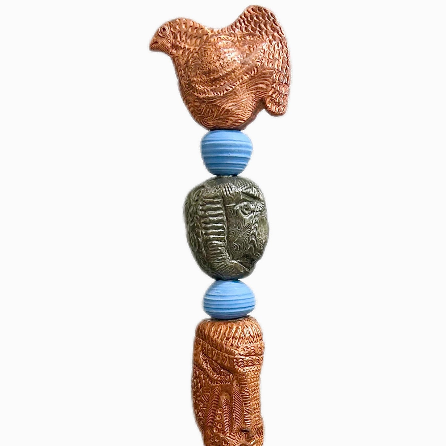 Stone Perch 4 by Zimmerman – detail of plump bird with layered scale marks holding warmth at crown of copper-bronze totem