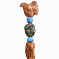 Stone Perch 4 by Zimmerman – detail of plump bird with layered scale marks holding warmth at crown of copper-bronze totem
