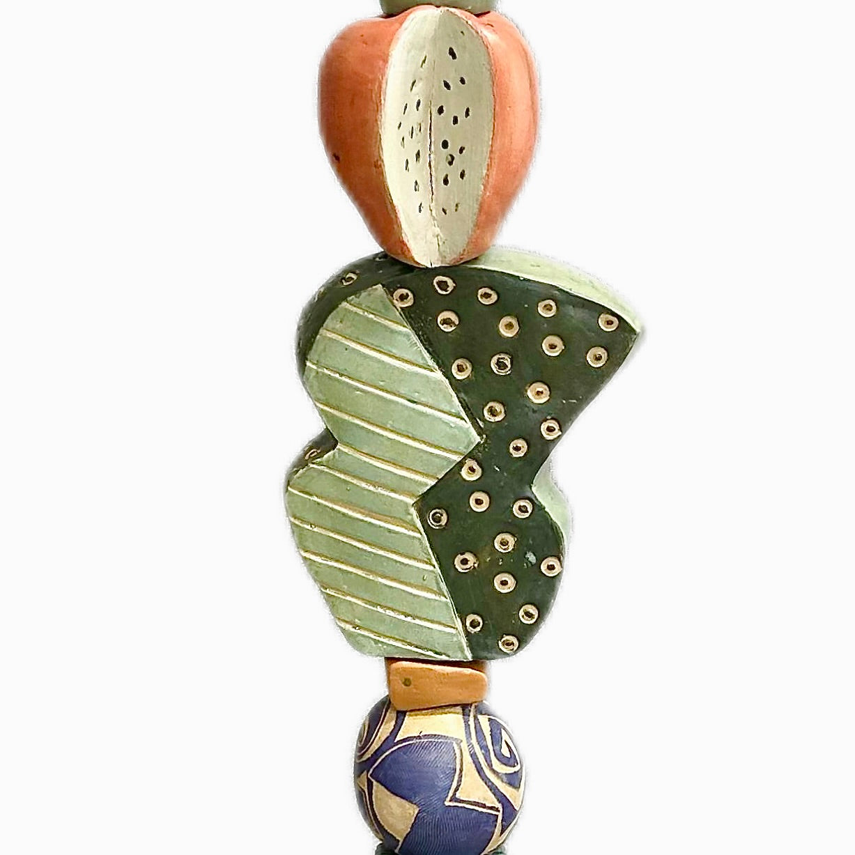 Juxtaposition 1 by Zimmerman – full view of totem with face dominating upper section, organic and geometric forms shifting below, and small hidden base face
