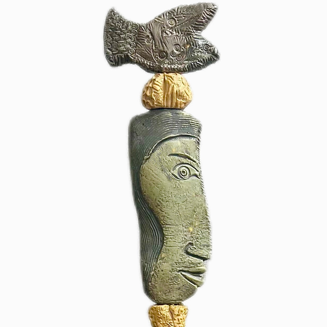 Stone Perch 1 by Zimmerman – detail of flat fish at crown with incised geometric marks and long sideways-looking face in coral-bronze ceramic totem