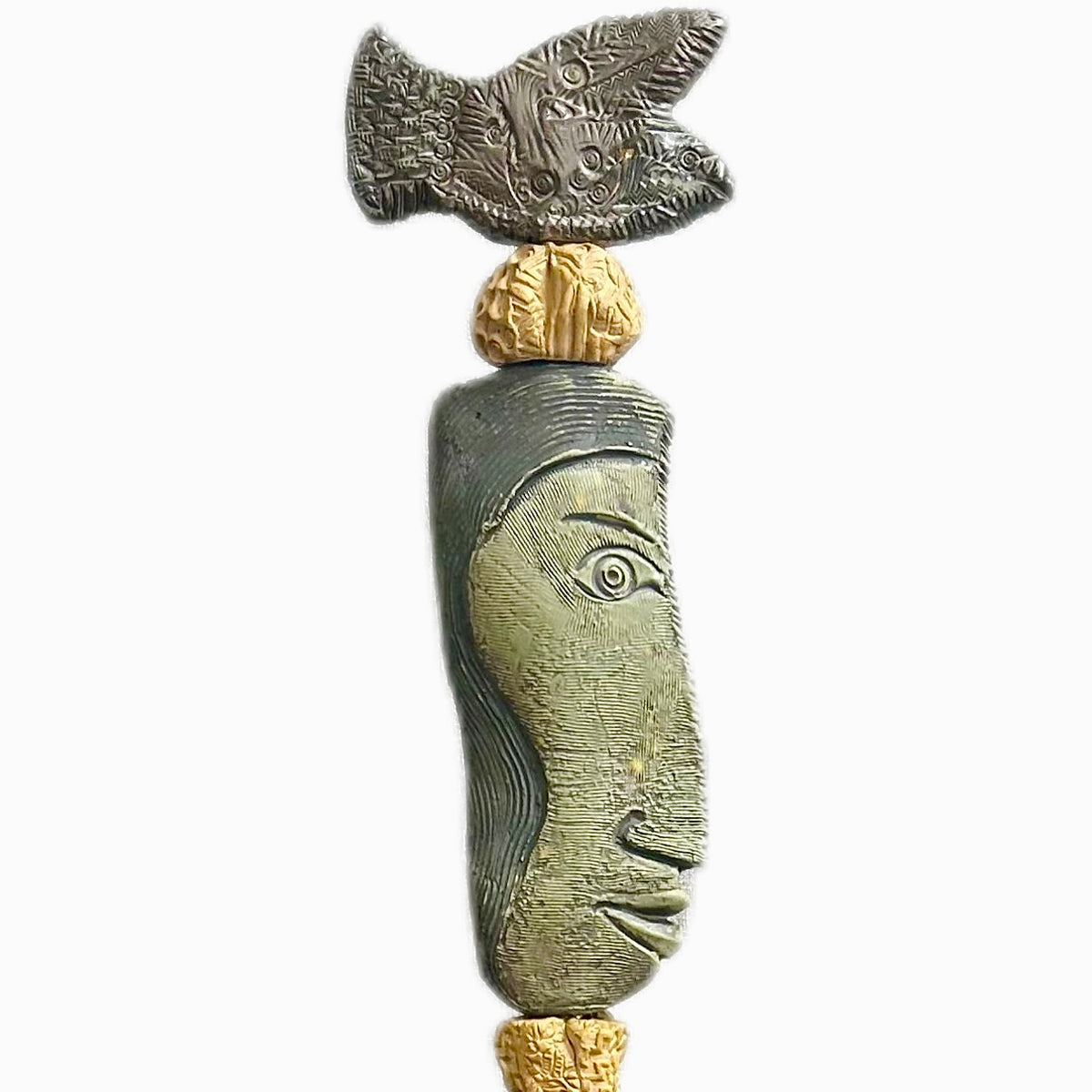 Stone Perch 1 by Zimmerman – detail of flat fish at crown with incised geometric marks and long sideways-looking face in coral-bronze ceramic totem