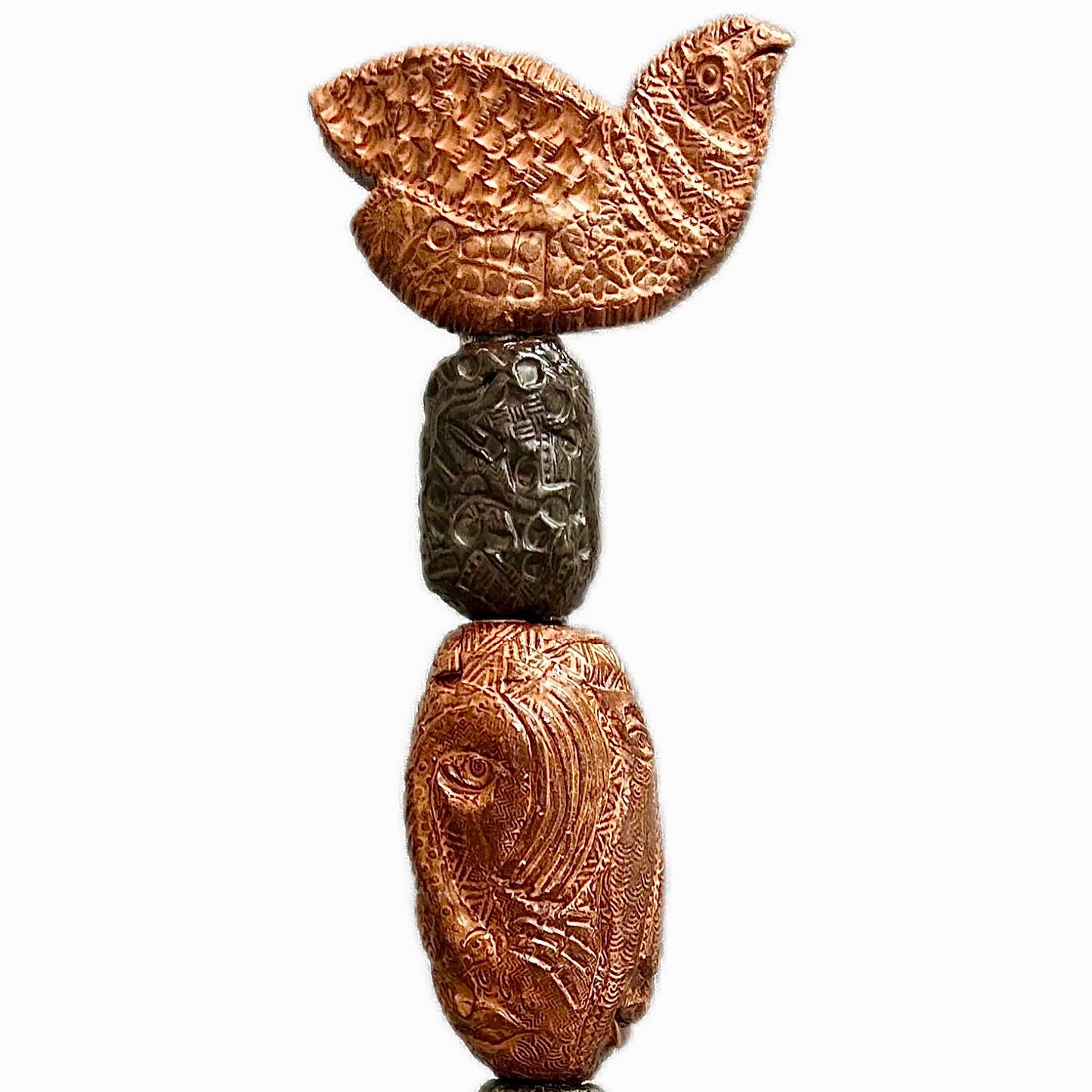 Stone Perch 2 by Zimmerman – detail of broad bird with wings open at crown of copper and charcoal stacked incised sphere totem