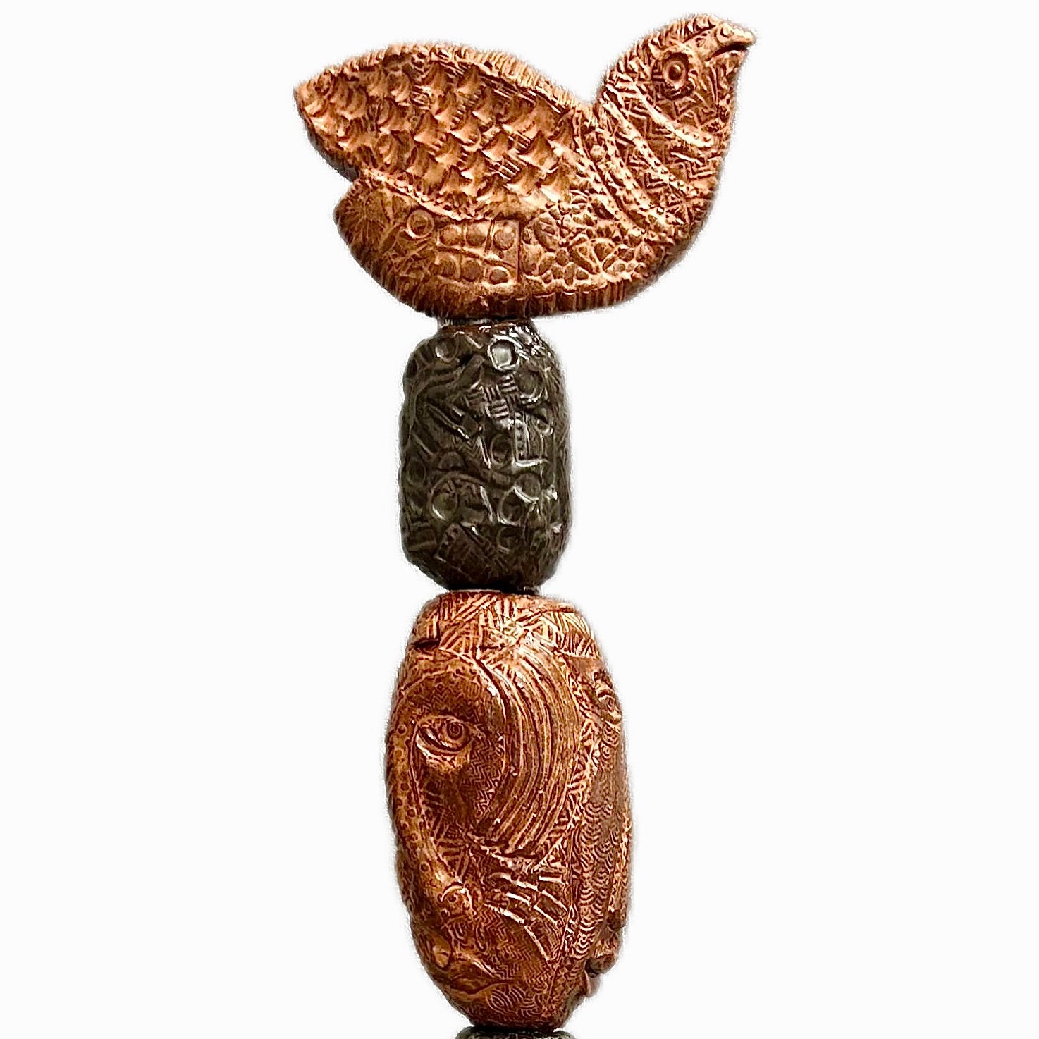 Stone Perch 2 by Zimmerman – detail of broad bird with wings open at crown of copper and charcoal stacked incised sphere totem