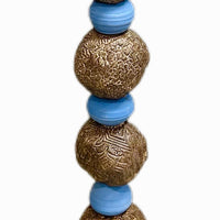 Stone Perch 5 by Zimmerman – full view of steady calming periwinkle and bronze totem with fish and figure at top