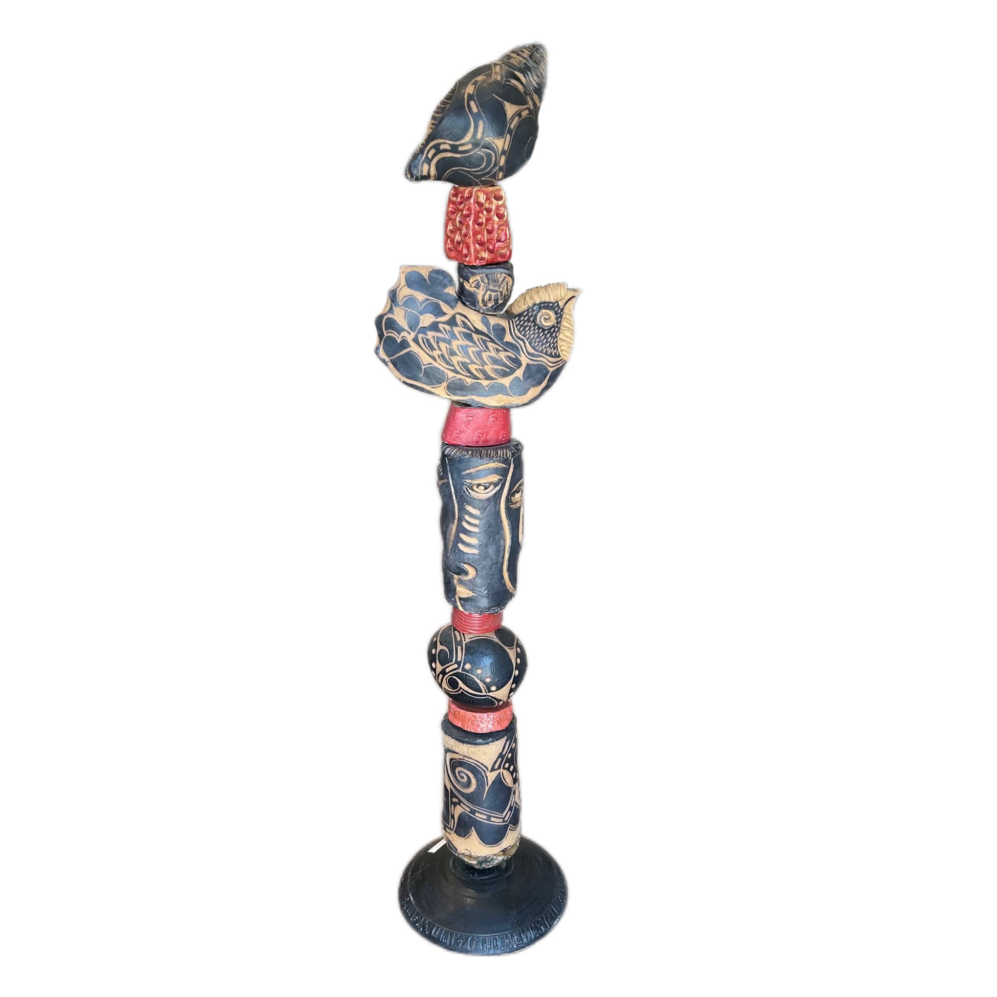 The Black Shell Ceramic Totem – hand-built ceramic totem by Zimmerman with large black and cream conch shell at crown with bold floral marks, wide bird, face from deep black cylinder with gold accents, red collar accents throughout nocturnal palette waiting to be discovered