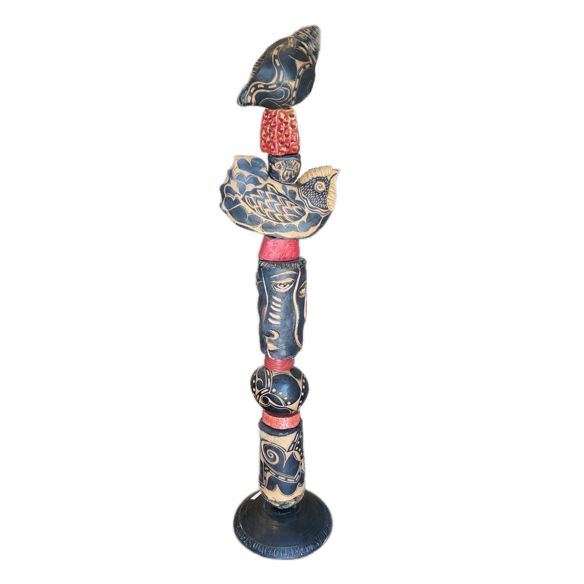 The Black Shell Ceramic Totem – hand-built ceramic totem by Zimmerman with large black and cream conch shell at crown with bold floral marks, wide bird, face from deep black cylinder with gold accents, red collar accents throughout nocturnal palette waiting to be discovered