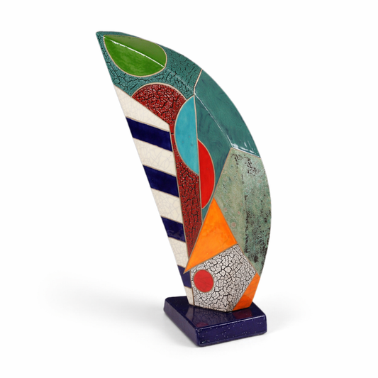 Eclipse 19 – large open studio raku ceramic sculpture by Gustavson with sage, warm orange, yellow, red, crackled white, and deep blue-grey on front with two black circular voids, and deep textured teal with crackled burgundy on reverse, on marble base