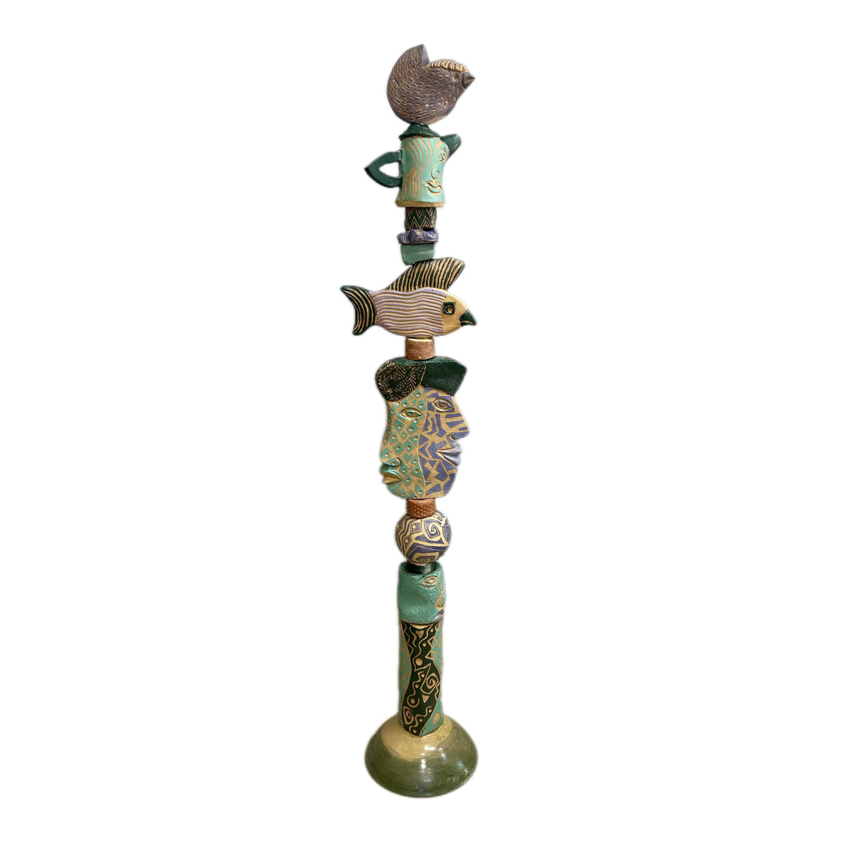 Juxtaposition 2 Ceramic Totem – hand-built ceramic totem by Zimmerman with small bird at top, large fish spreading wide in purple, gold, and black stripes, teal and purple geometric face below, bold black and gold abstract base marks from printmaking vocabulary