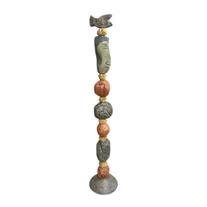 Stone Perch 1 Ceramic Totem – 71-inch hand-built ceramic totem by Zimmerman with flat fish at crown mapped in incised geometric marks, long sideways-looking face below, alternating coral-bronze and charcoal forms with spirals and botanical marks on patterned disc base