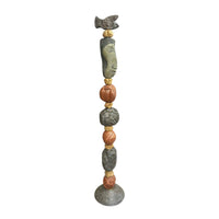 Stone Perch 1 Ceramic Totem – 71-inch hand-built ceramic totem by Zimmerman with flat fish at crown mapped in incised geometric marks, long sideways-looking face below, alternating coral-bronze and charcoal forms with spirals and botanical marks on patterned disc base