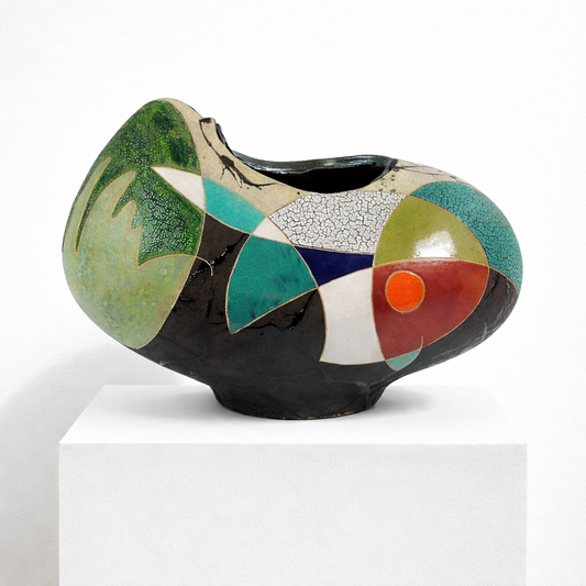Winter Wind Vessel – wide low studio raku ceramic vessel by Gustavson with deep black ground carrying bold planes of green, teal, cream, and red, fine crackle recording kiln heat, two sides reading differently from each other