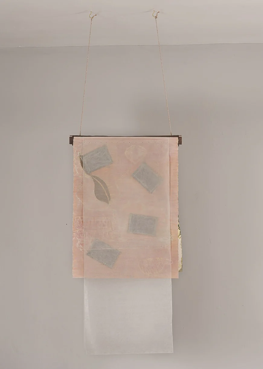 Untitled Pink – suspended textile work by Terese Garcia with soft blush pink semi-transparent fabric hanging from thin rod, small rectangular grey forms pressed between panels like specimens, casting faint shadow