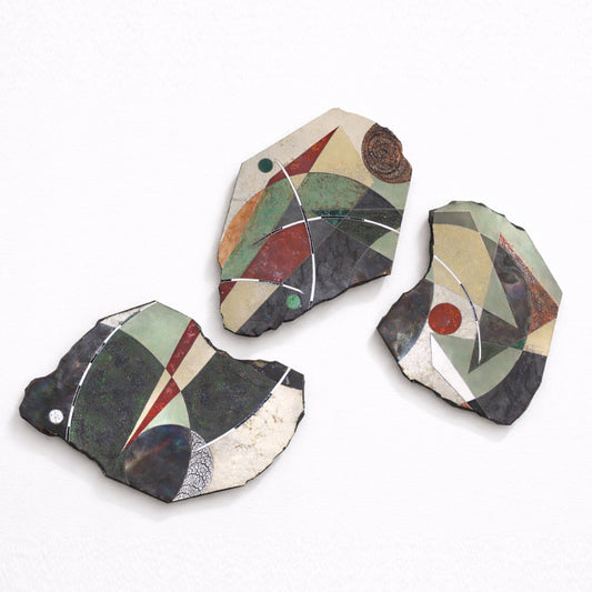 Just South of the Moon Triptych – three organic ceramic slab wall piece by Gustavson in soft greens, warm creams, greys, and earthy reds with circular forms and deliberate negative space between slabs