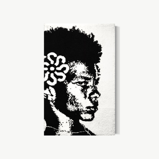 Lago – tufted acrylic yarn artwork by Cedric Vu in high-contrast black and white with a face emerging from curling forms and white flowers threading through the hair, dense tactile texture resolving into graphic striking image
