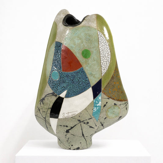 Changing Hues Vessel – studio raku ceramic by Gustavson with soft grey-green and cream glaze with passages of deep red, black, and teal on a tilting weightless form