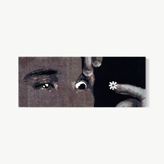 GRWM – horizontal tufted acrylic yarn self portrait by Cedric Vu with close-up face fragments of eyes, nose, and hand with small white flower in dark field, cinematic framing turning everyday ritual into something magnetic