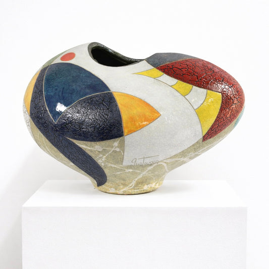 Dream a Little Vessel – studio raku ceramic by Gustavson with bold sections of deep navy, warm grey, yellow, orange, and red glaze with small circular marks on a low wide form